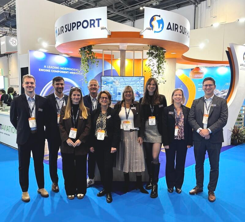 The Air Support team posing together in front of their exhibition stand at the MRO Europe aviation show in London.